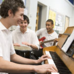 Students playing various instruments in a classroom